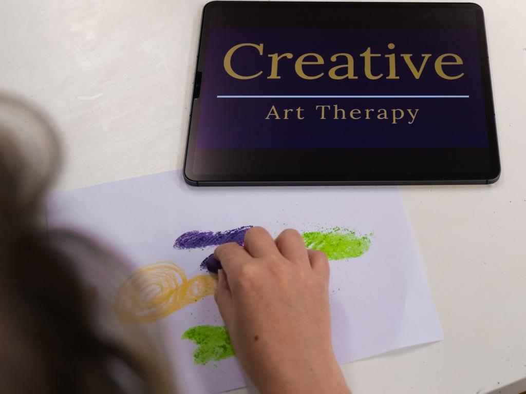 Colouring in beside ipad with logo showing